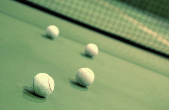 Four tennis balls on a tennis court