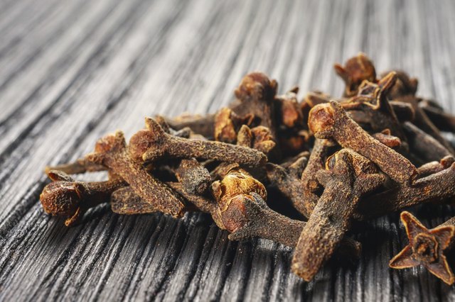 pile cloves on wood background