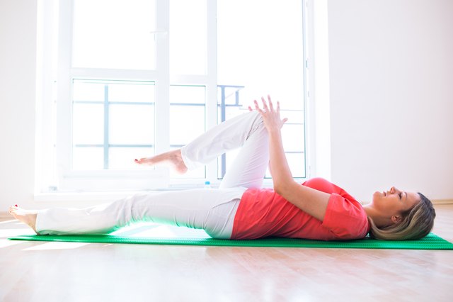 Pretty young woman doing YOGA exercise at home