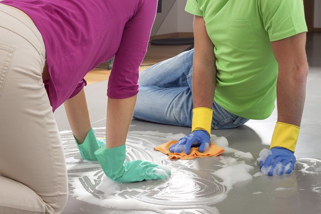 Couple cleaning floor