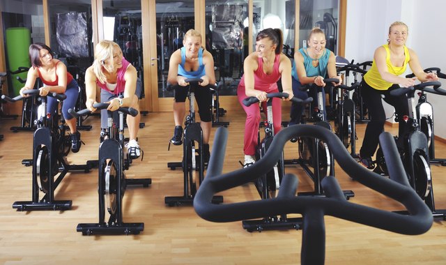 Beautiful women doing exercise in a spinning class at gym