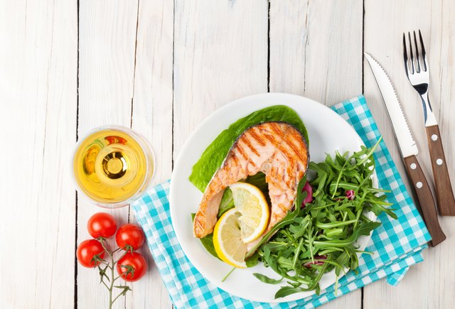 Grilled salmon and whtie wine on wooden table