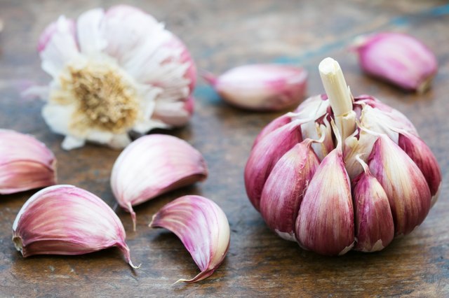Garlic bulbs and cloves on wooden background