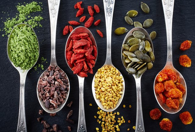 Superfoods in separate spoons laid next to each other