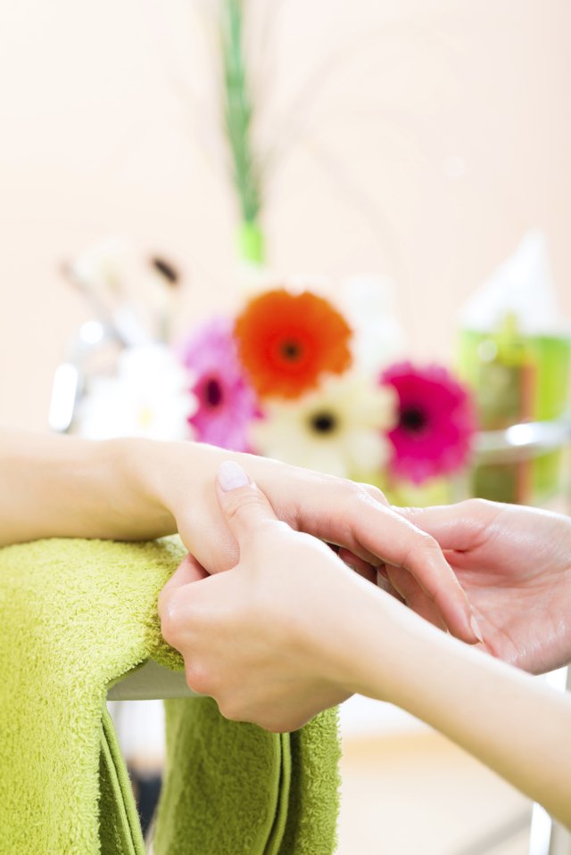 Woman in nail salon receiving hand massage