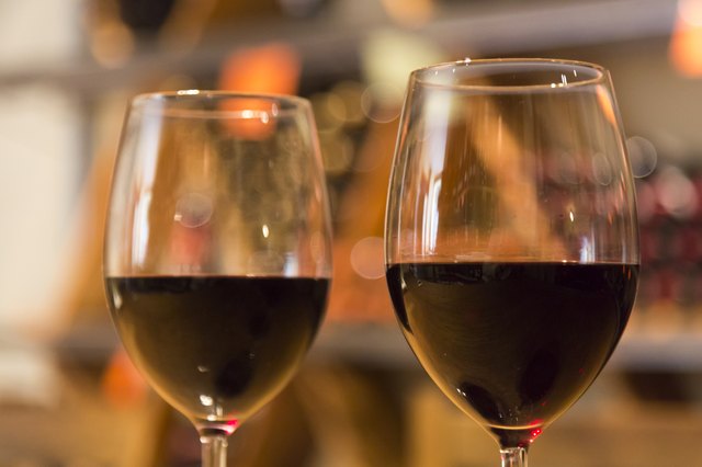Line of two wine glasses full of wine
