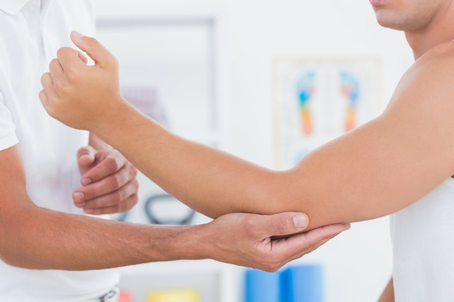 Doctor examining his patient arm