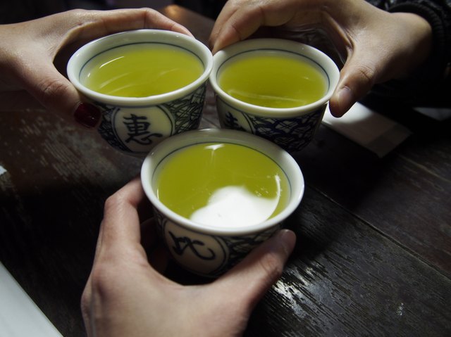 clink glasses, drinking green tea