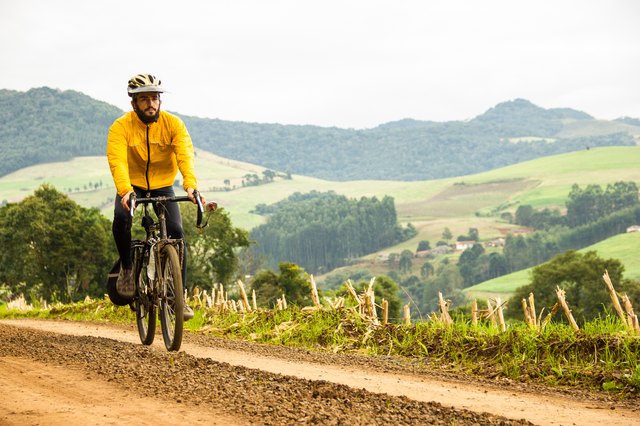 Front View of a Man With Bicycle on unpaved road