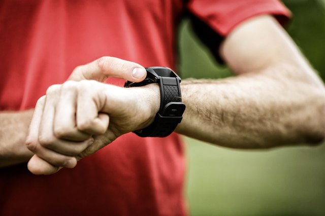 Runner looking at sports watch