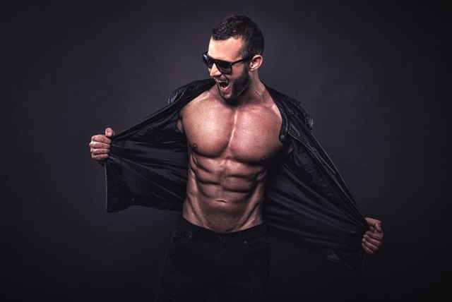 Crazy fit man posing in studio.