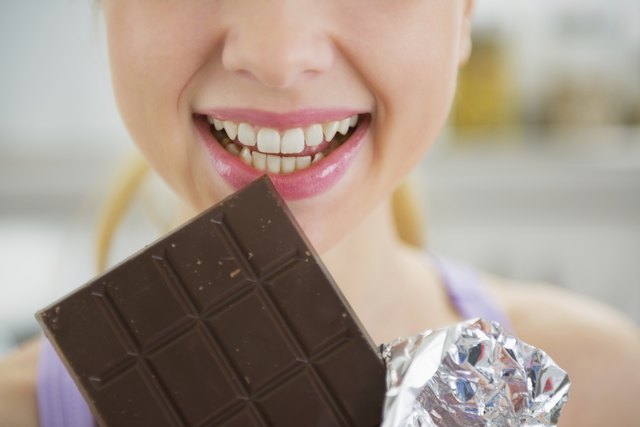 closeup on young woman eating chocolate