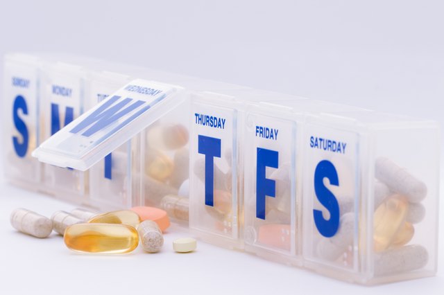 Daily vitamin and supplement pills with organizer