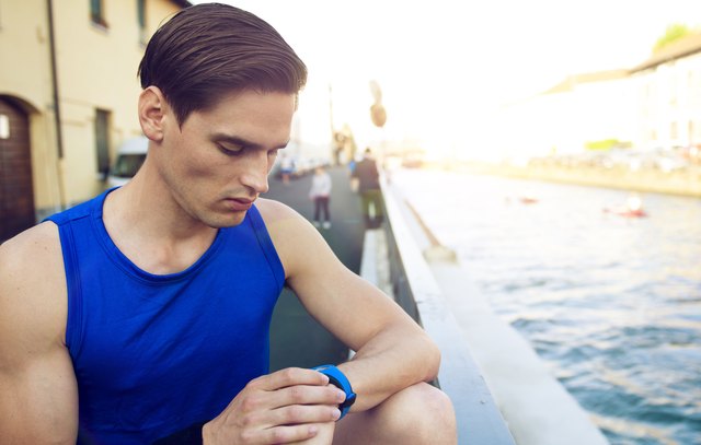 Handsome athlete checking pulse