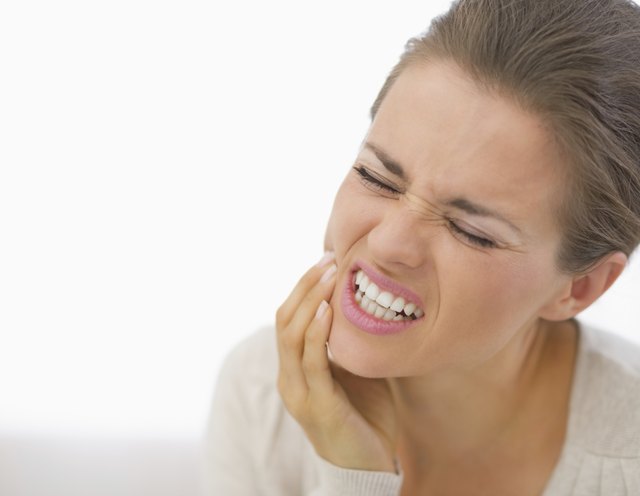 portrait of young woman with toothache