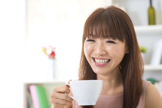 Asian woman enjoying coffee