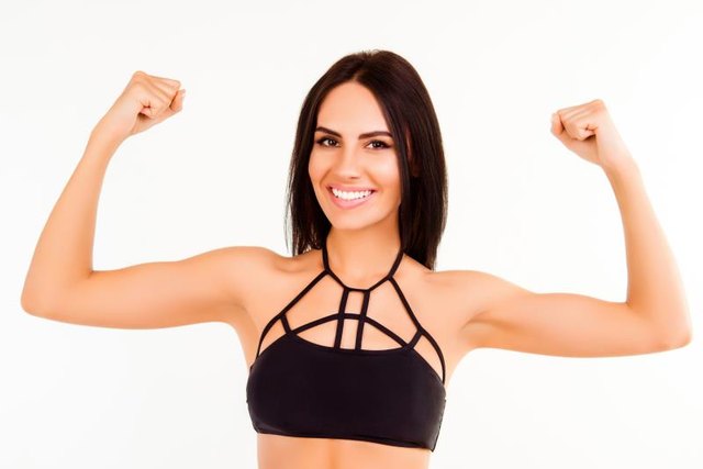 Healthy fit young woman demonstrating her strong arms