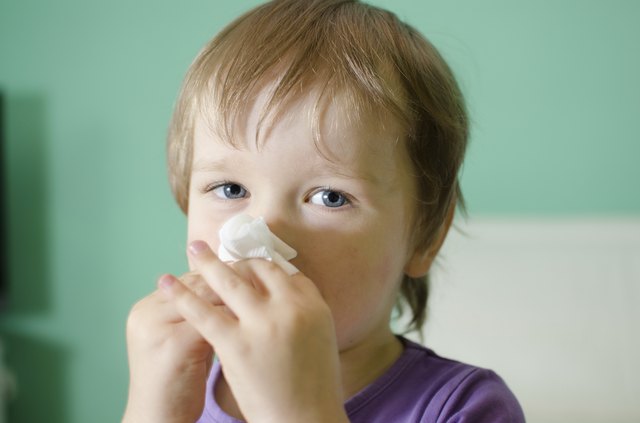 Little boy cleaning nose