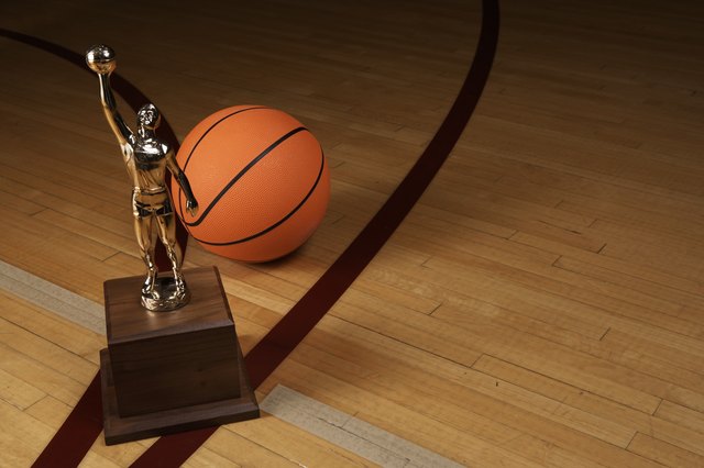 Basketball and trophy on basketball court, elevated view