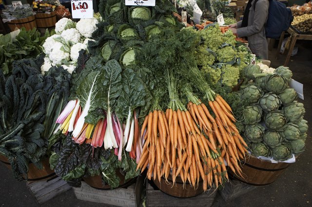 Carrots, chard, artichokes, greens and cauliflowers on market stall