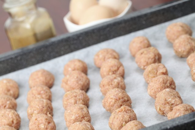 Raw meatballs on baking sheet