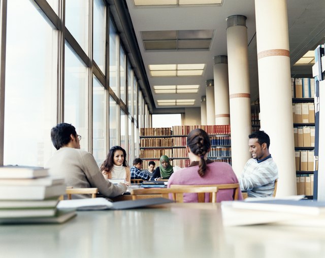Surface Level Shot of Mature Students Studying at a Table in a University Library