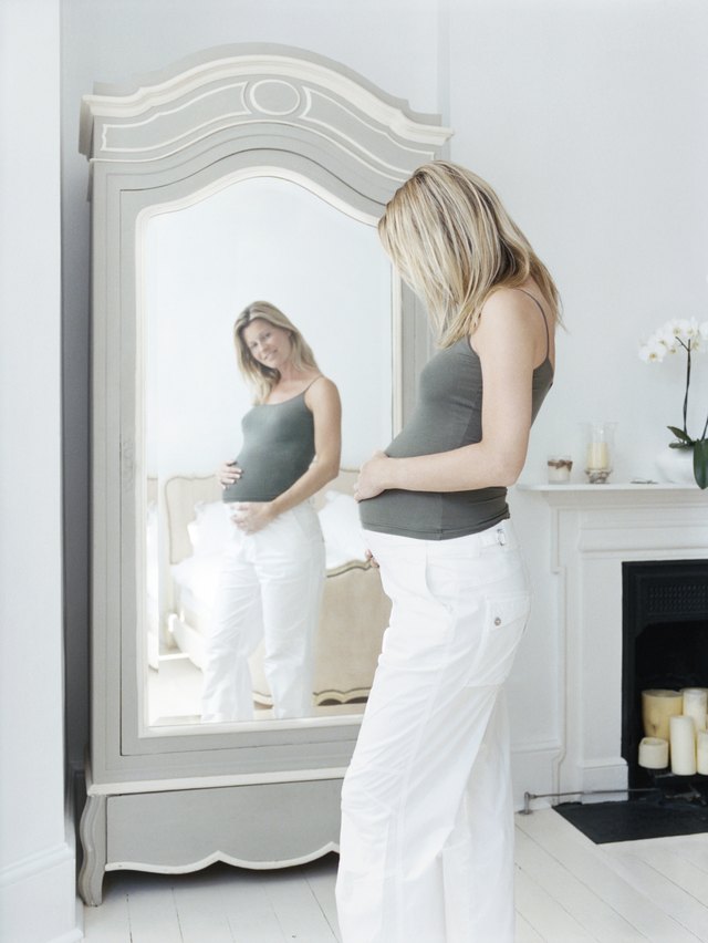Pregnant Woman Looking at Her Reflection in a Mirror