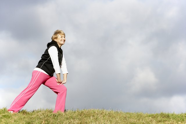 Senior Woman Stretching In Park
