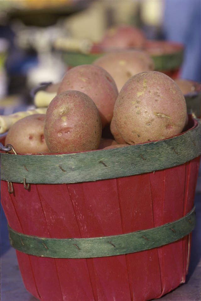 Close-up of potatoes in a wooden bucket