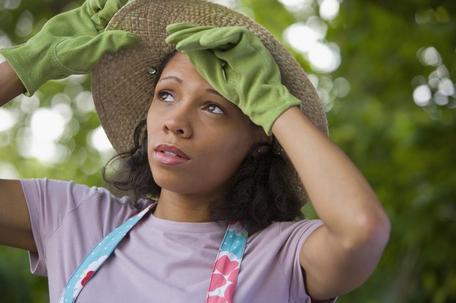 African American woman wearing gardening gloves