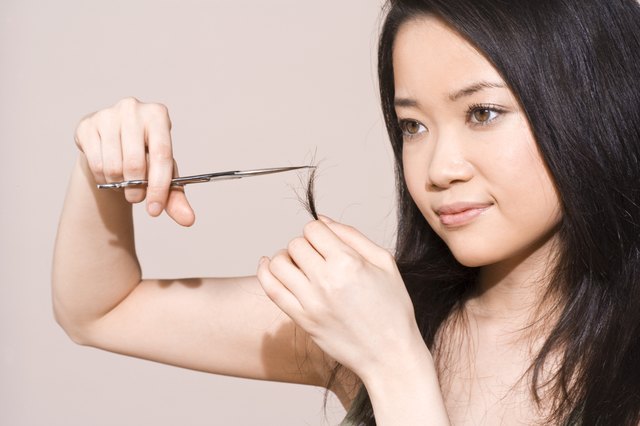 Woman trimming split-ends