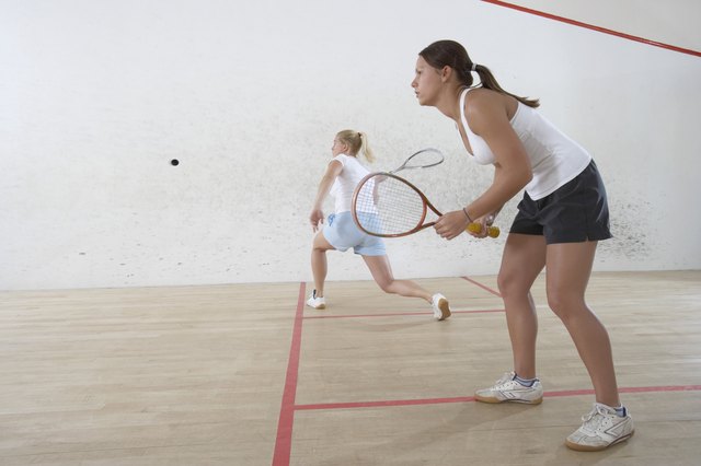 Two Young Women Playing Squash