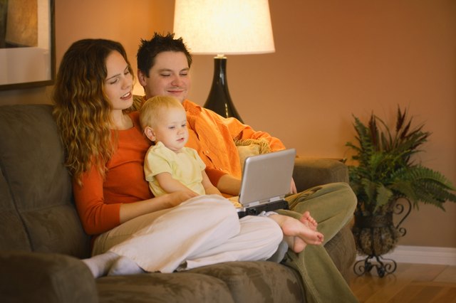 young family watching movie on portable DVD player