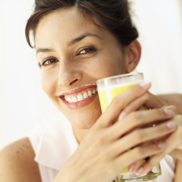 close-up of a young woman drinking a glass of milk