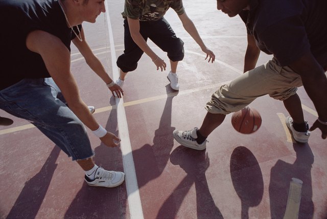 Teenagers playing basketball