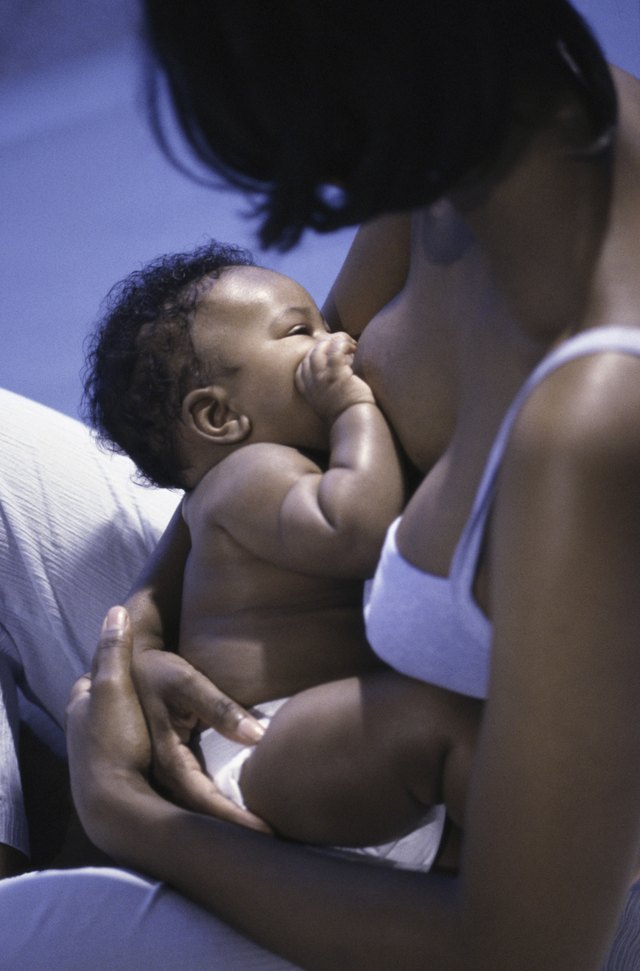 High angle view of a mother breastfeeding her baby boy