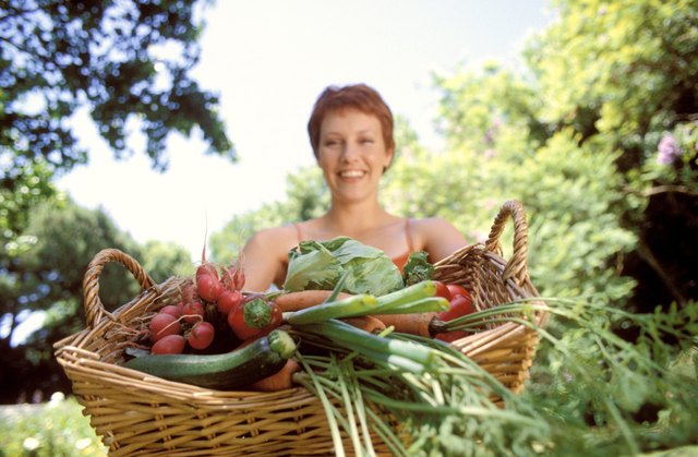 Woman holding basket of vegetables