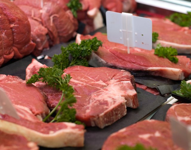 Display of raw steaks in grocery