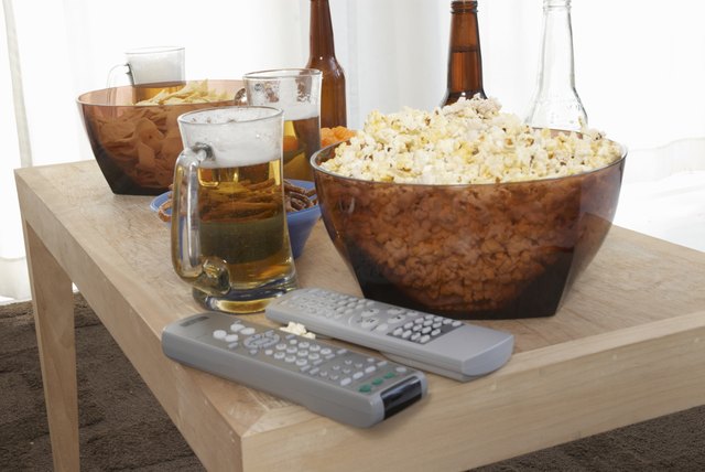 Popcorn, beer, and remote controls on coffee table