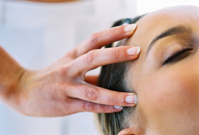 close-up of a young woman getting a head massage