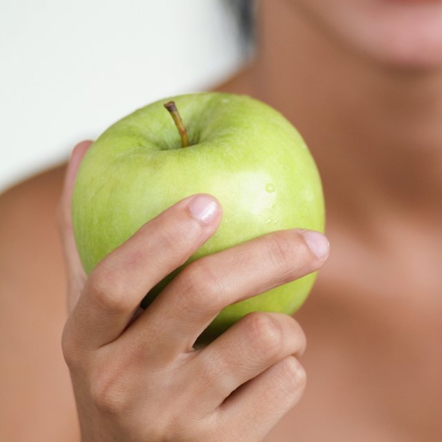 Young woman holding a green apple