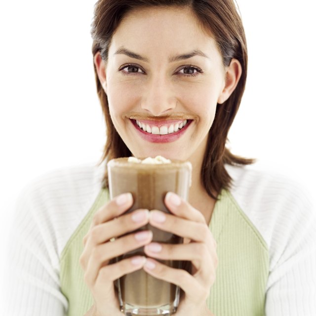 portrait of a young woman drinking a chocolate milkshake