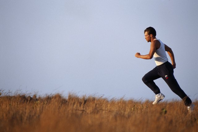 Mid adult man running, side view