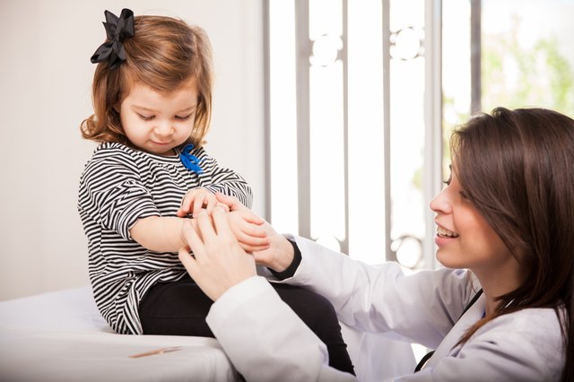 Pediatrician applying a bandage