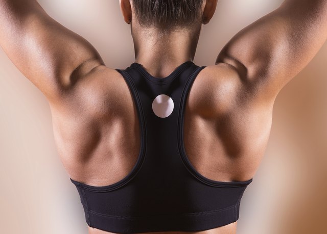 Woman's back in the fitness room.
