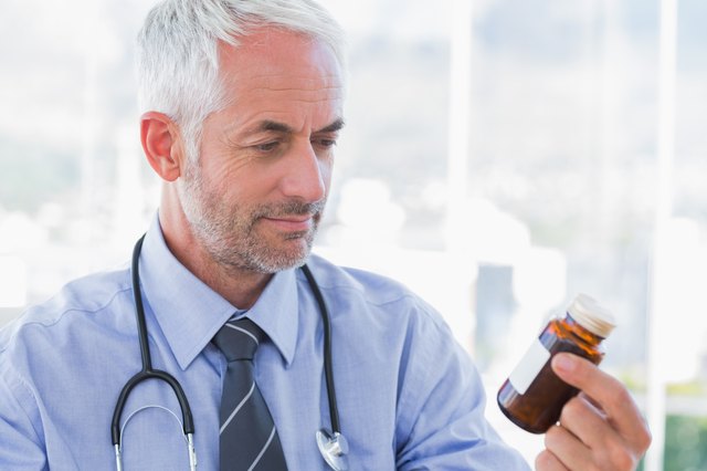 Doctor looking at medicine jar
