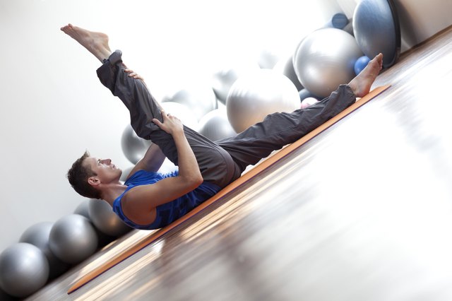 fusion of mind and body - man practicing pilates