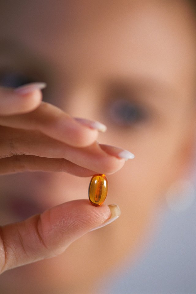 Close-up of woman's hand holding capsule