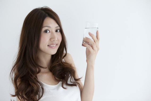 Young woman holding a glass of water
