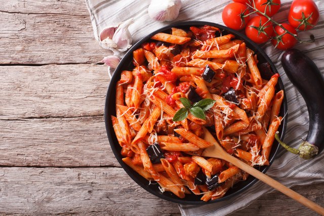 Italian Pasta alla Norma close-up and ingredients. horizontal to
